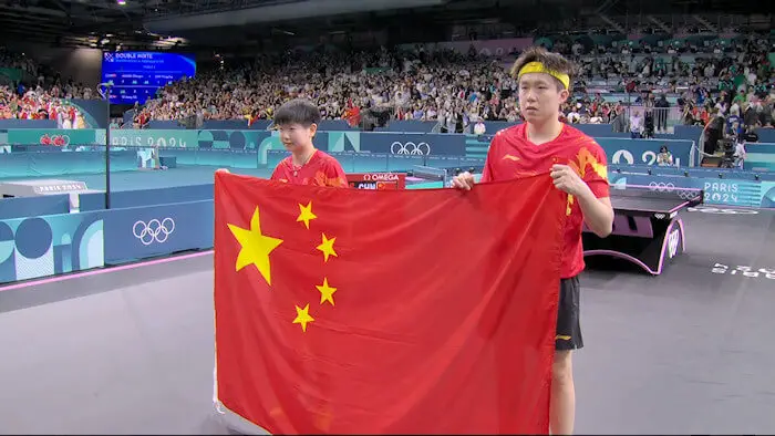 SUN Yingsha and WANG Chuqin (China) with national flag